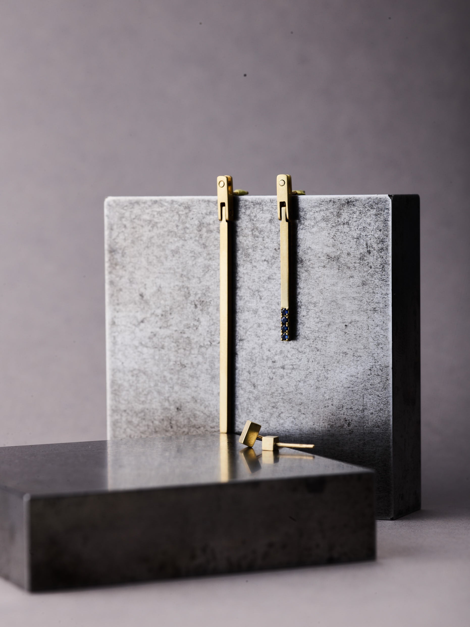 Focus-dot-earring-paired-with-concrete-square